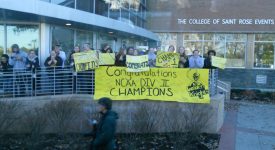Saint Rose students holding "Congratulations NCAA DIV II Champions" sign out side of campus